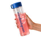 One mindbodygreen water bottle held in hand with pink liquid